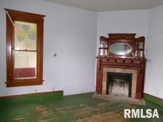 896 E Chestnut St, Canton, IL 61520 - unfurnished living room featuring a fireplace with flush hearth
