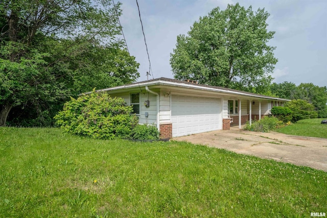 23907 Veterans Rd, Morton, IL 61550 - view of front facade with an attached garage, concrete driveway, a front yard, and brick siding