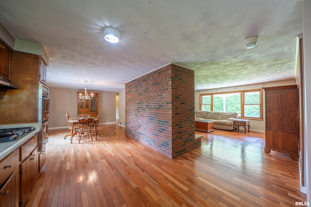 23907 Veterans Rd, Morton, IL 61550 - kitchen featuring appliances with stainless steel finishes, a chandelier, light wood-style floors, and baseboards