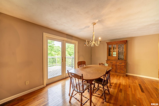 23907 Veterans Rd, Morton, IL 61550 - dining area featuring baseboards, a chandelier, and light wood-style floors
