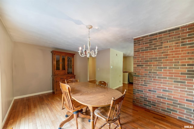 23907 Veterans Rd, Morton, IL 61550 - dining room with hardwood / wood-style floors, a chandelier, and baseboards