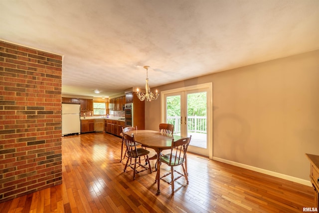 23907 Veterans Rd, Morton, IL 61550 - dining space with wood-type flooring, a chandelier, and baseboards