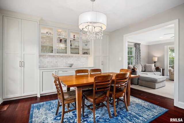 4407 N Grandview Dr, Peoria Heights, IL 61483 - dining room featuring dark wood-style floors, plenty of natural light, a chandelier, and crown molding