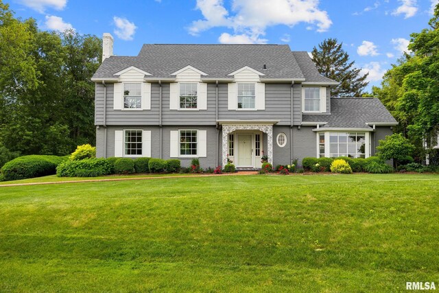 4407 N Grandview Dr, Peoria Heights, IL 61483 - view of front of home featuring a chimney, a front yard, and a shingled roof