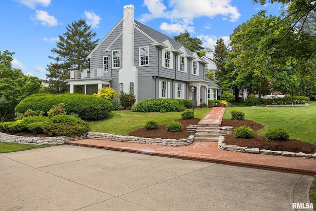 4407 N Grandview Dr, Peoria Heights, IL 61483 - view of front of home featuring a front yard, a chimney, and a balcony