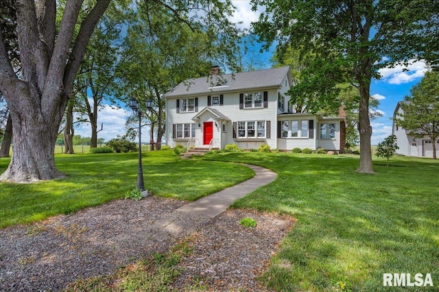 701 E Pearl St, Tremont, IL 61568 - colonial home featuring a chimney and a front lawn