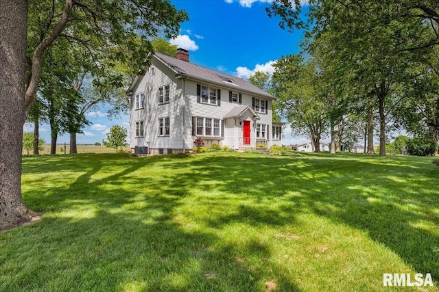 701 E Pearl St, Tremont, IL 61568 - colonial inspired home featuring a chimney, a front lawn, and central air condition unit