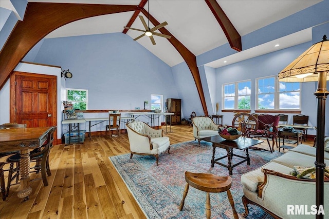 701 E Pearl St, Tremont, IL 61568 - living area featuring high vaulted ceiling, a ceiling fan, arched walkways, plenty of natural light, and hardwood / wood-style floors