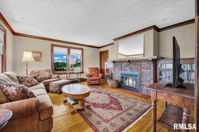 701 E Pearl St, Tremont, IL 61568 - living room featuring ornamental molding, wood finished floors, and a brick fireplace