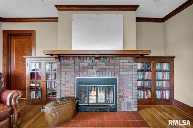 701 E Pearl St, Tremont, IL 61568 - detailed view of ornamental molding, a fireplace, and wood finished floors
