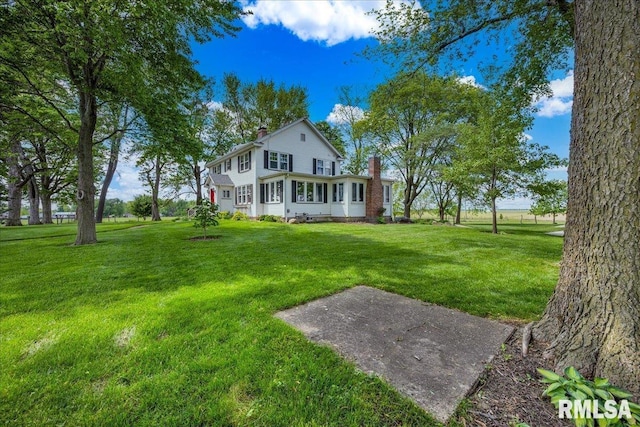 701 E Pearl St, Tremont, IL 61568 - rear view of property with a chimney and a yard