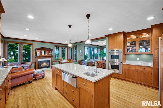 701 E Pearl St, Tremont, IL 61568 - kitchen featuring a sink, double oven, a warming drawer, open floor plan, and a glass covered fireplace