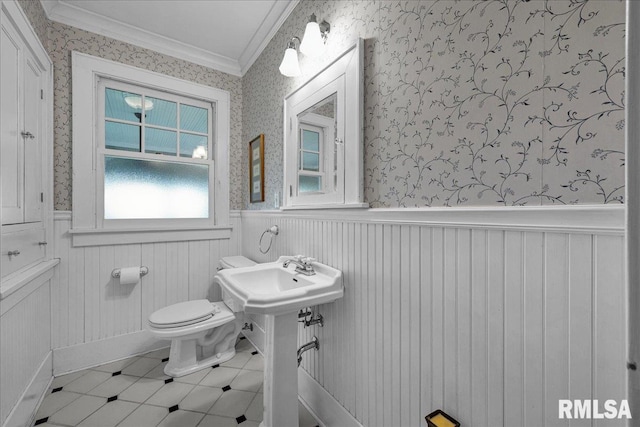 701 E Pearl St, Tremont, IL 61568 - bathroom featuring a wainscoted wall, crown molding, toilet, wallpapered walls, and a sink