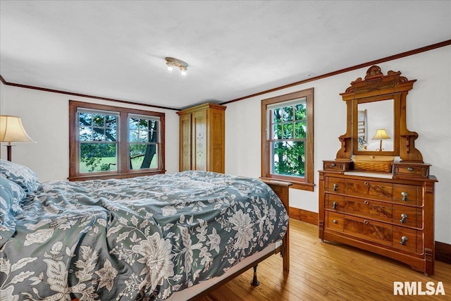 701 E Pearl St, Tremont, IL 61568 - bedroom featuring light wood-style floors, crown molding, and baseboards