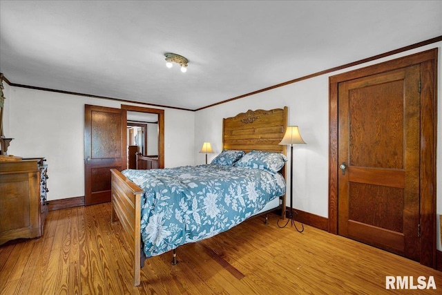 701 E Pearl St, Tremont, IL 61568 - bedroom with baseboards, wood finished floors, and crown molding