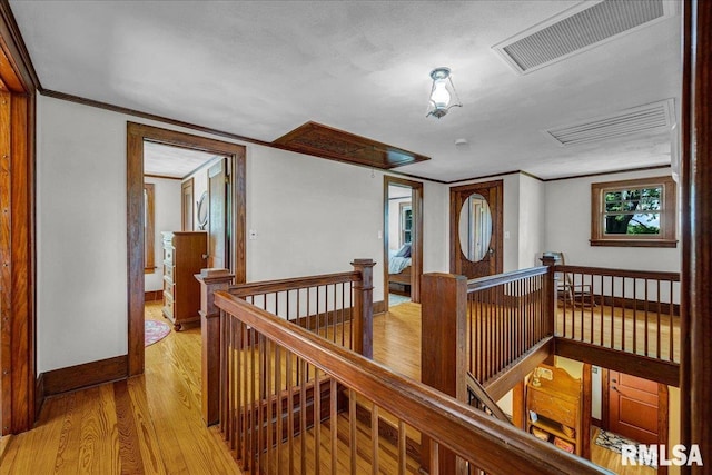 701 E Pearl St, Tremont, IL 61568 - hall with an upstairs landing, light wood-type flooring, attic access, baseboards, and ornamental molding