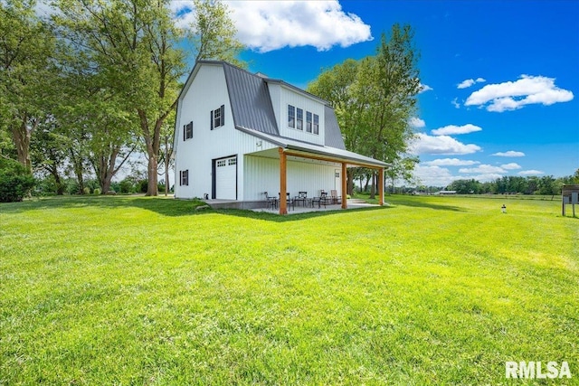 701 E Pearl St, Tremont, IL 61568 - rear view of house with a lawn, metal roof, a patio, and a gambrel roof
