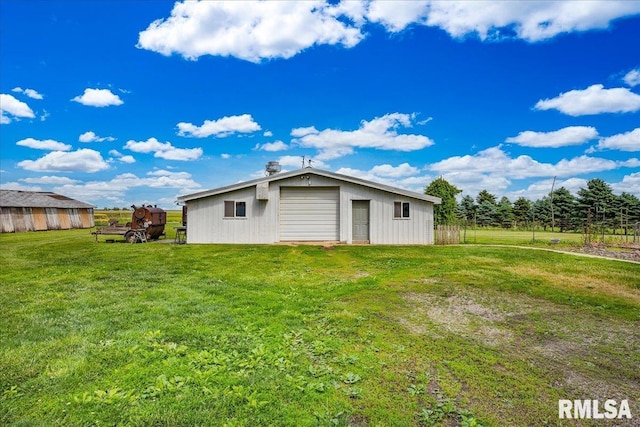 701 E Pearl St, Tremont, IL 61568 - back of property with an outdoor structure and a lawn