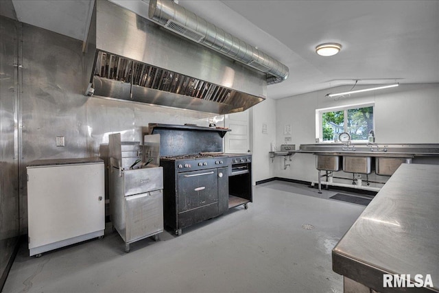701 E Pearl St, Tremont, IL 61568 - kitchen featuring concrete floors, wall chimney range hood, and baseboards
