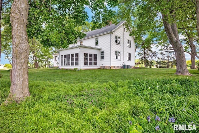 701 E Pearl St, Tremont, IL 61568 - rear view of house with a lawn and central air condition unit