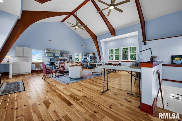 701 E Pearl St, Tremont, IL 61568 - living area with ceiling fan, arched walkways, high vaulted ceiling, light wood-style flooring, and beam ceiling