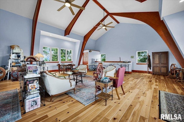 701 E Pearl St, Tremont, IL 61568 - living room featuring ceiling fan, arched walkways, hardwood / wood-style floors, high vaulted ceiling, and beam ceiling