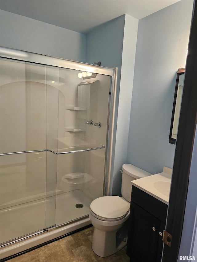 723 E Maywood Ave, Peoria, IL 61603 - full bathroom featuring a shower stall, vanity, and toilet