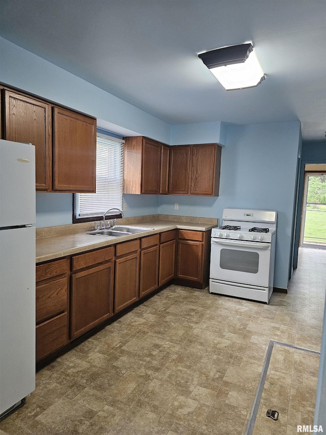 723 E Maywood Ave, Peoria, IL 61603 - kitchen featuring white appliances, a sink, light countertops, and brown cabinetry