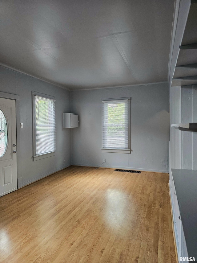 723 E Maywood Ave, Peoria, IL 61603 - unfurnished living room with plenty of natural light and light wood-style floors