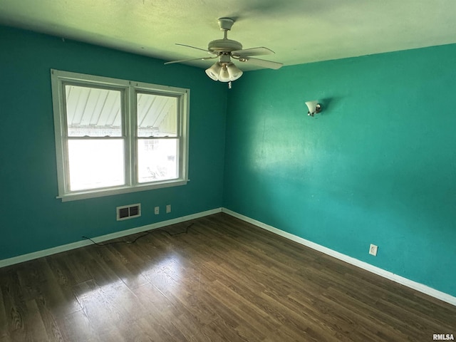 4405 Silvis Rd, Bartonville, IL 61607 - unfurnished room with dark wood-style floors, a ceiling fan, and baseboards