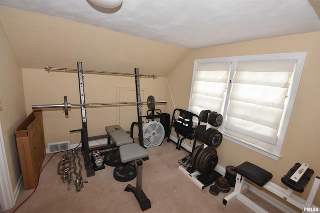 306 William St, East Peoria, IL 61611 - exercise area featuring carpet flooring, vaulted ceiling, and baseboards