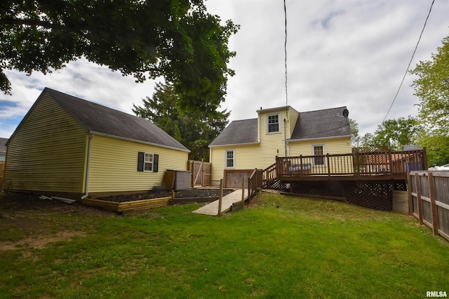 306 William St, East Peoria, IL 61611 - rear view of house featuring a vegetable garden and a wooden deck