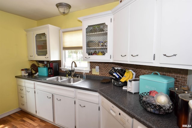 306 William St, East Peoria, IL 61611 - kitchen featuring a sink, dishwasher, dark countertops, and decorative backsplash