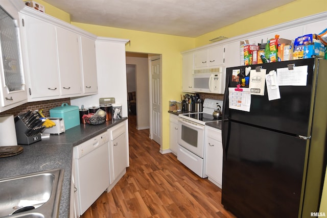 306 William St, East Peoria, IL 61611 - kitchen featuring white appliances, dark countertops, white cabinets, and wood finished floors