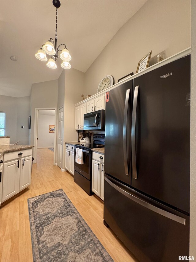 1041 Hawthorn Rdg, Macomb, IL 61455 - kitchen featuring black electric range, freestanding refrigerator, white cabinetry, a chandelier, and vaulted ceiling