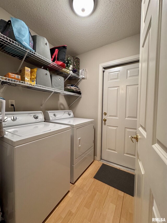 1041 Hawthorn Rdg, Macomb, IL 61455 - laundry area with light wood finished floors, washer and clothes dryer, and a textured ceiling