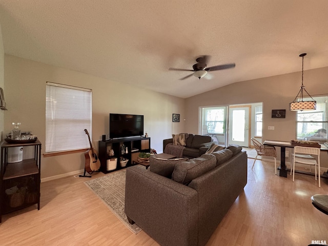 1041 Hawthorn Rdg, Macomb, IL 61455 - living room with vaulted ceiling, ceiling fan, plenty of natural light, light wood-type flooring, and a textured ceiling