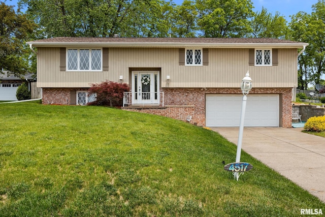 4517 W Hetherwood Dr, Peoria, IL 61615 - split foyer home with an attached garage, concrete driveway, a front yard, and brick siding