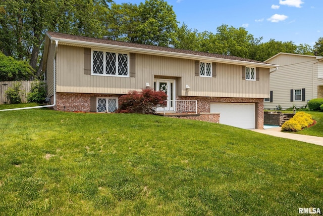 4517 W Hetherwood Dr, Peoria, IL 61615 - raised ranch featuring a garage, brick siding, and driveway