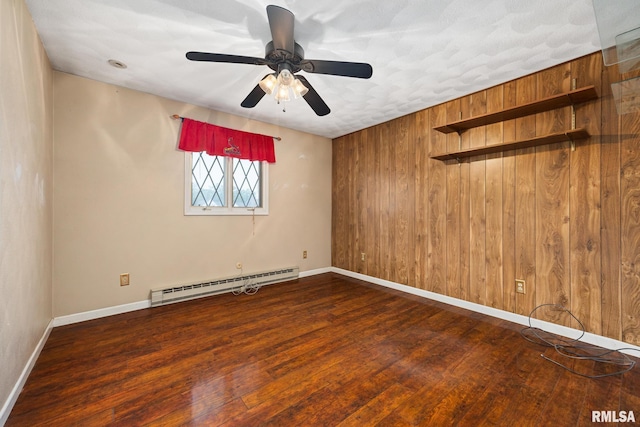 4517 W Hetherwood Dr, Peoria, IL 61615 - empty room with a baseboard heating unit, wood finished floors, a ceiling fan, and baseboards