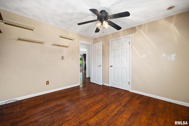 4517 W Hetherwood Dr, Peoria, IL 61615 - unfurnished bedroom with baseboards, wood finished floors, and a ceiling fan