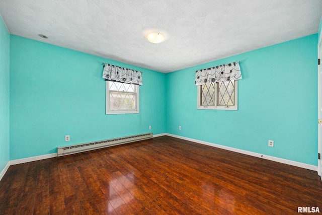 4517 W Hetherwood Dr, Peoria, IL 61615 - spare room with baseboard heating, wood finished floors, and baseboards