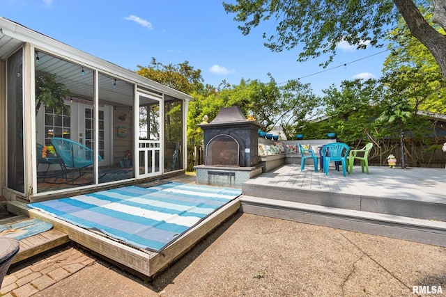 4517 W Hetherwood Dr, Peoria, IL 61615 - deck featuring an outdoor fireplace, a sunroom, and french doors