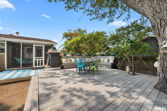4517 W Hetherwood Dr, Peoria, IL 61615 - wooden deck featuring a sunroom, a fenced backyard, and outdoor dining space