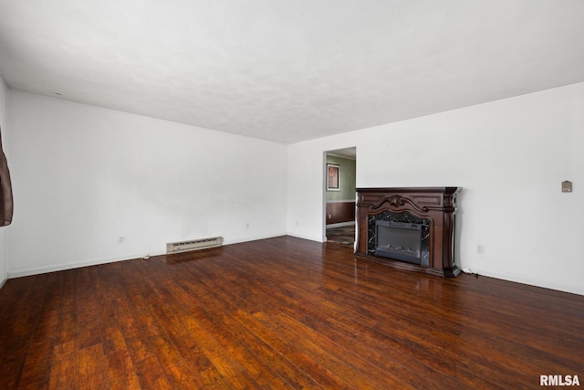 4517 W Hetherwood Dr, Peoria, IL 61615 - unfurnished living room with wood finished floors, a fireplace, a baseboard heating unit, and baseboards