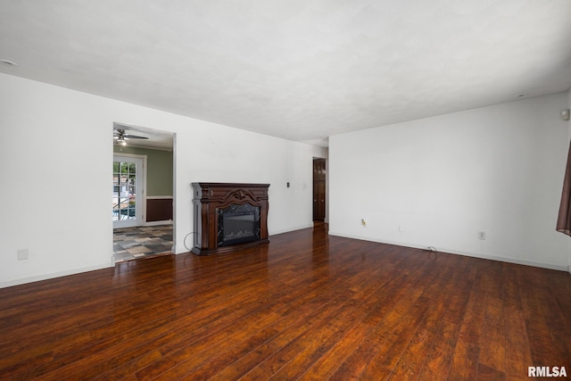 4517 W Hetherwood Dr, Peoria, IL 61615 - unfurnished living room featuring wood finished floors, a fireplace, baseboards, and a ceiling fan