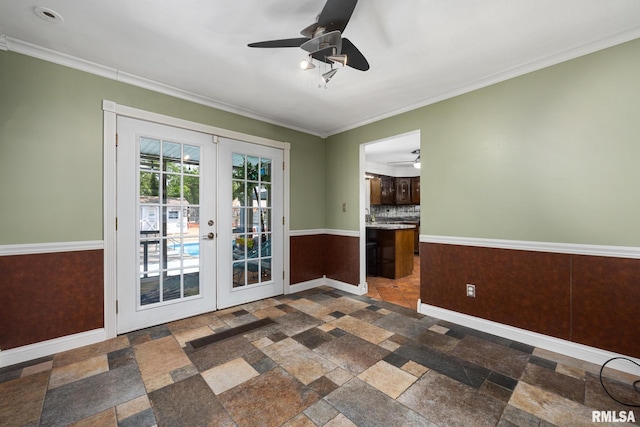 4517 W Hetherwood Dr, Peoria, IL 61615 - spare room featuring french doors, ceiling fan, stone tile flooring, baseboards, and crown molding