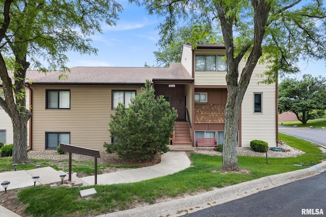 6500 N Allen Rd Unit 62, Peoria, IL 61614 - view of front of property featuring a front lawn, a shingled roof, and stairs
