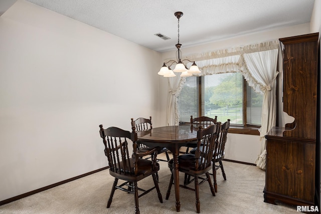 6500 N Allen Rd Unit 62, Peoria, IL 61614 - dining room featuring light carpet, a chandelier, and baseboards