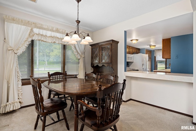 6500 N Allen Rd Unit 62, Peoria, IL 61614 - dining area with a chandelier, light colored carpet, and baseboards